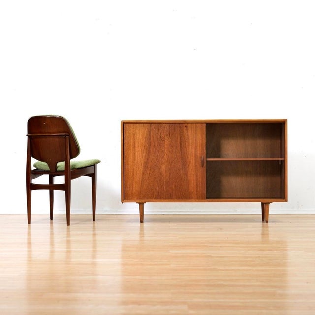 This vintage mid-century china cabinet was produced in England during the 1960s. Made from teak, this minimalist cabinet...