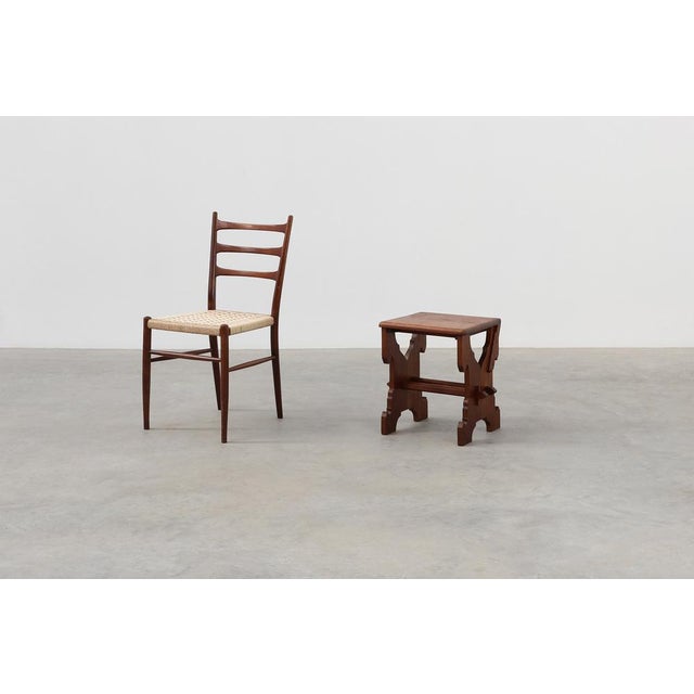 A characterful Belgian oak stool from circa 1890, positioned at the intersection of Arts & Crafts integrity and early...