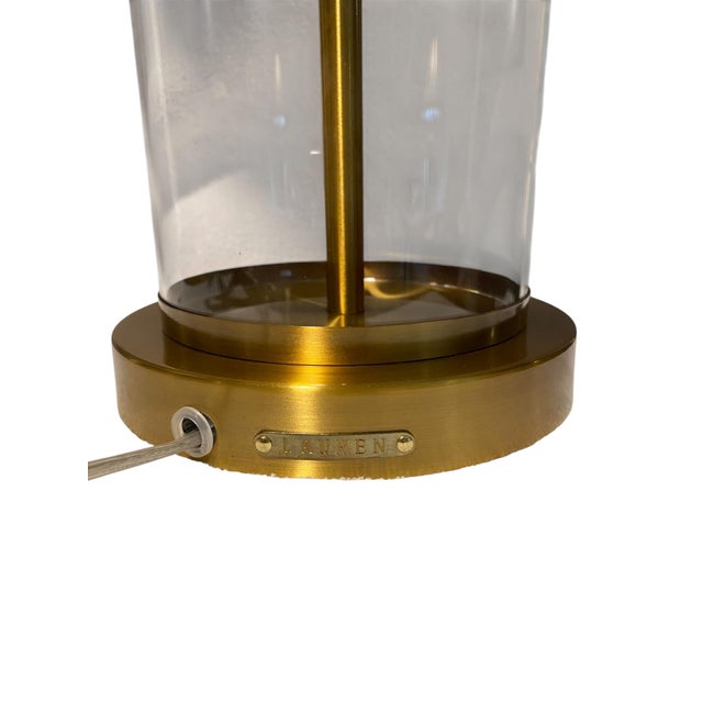 A refined pair of vintage Ralph Lauren table lamps featuring clear cylindrical glass bodies with polished brass bases and...