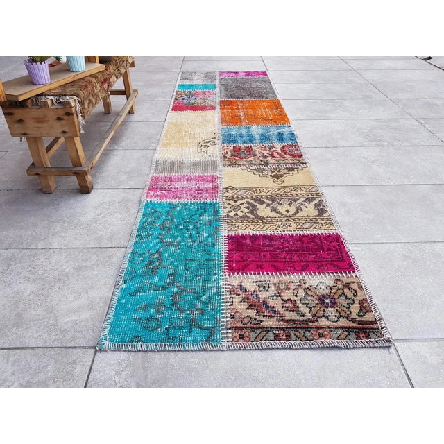 This is a vintage Turkish Oushak rug from the Mid 20th Century. The piece was hand-knotted.