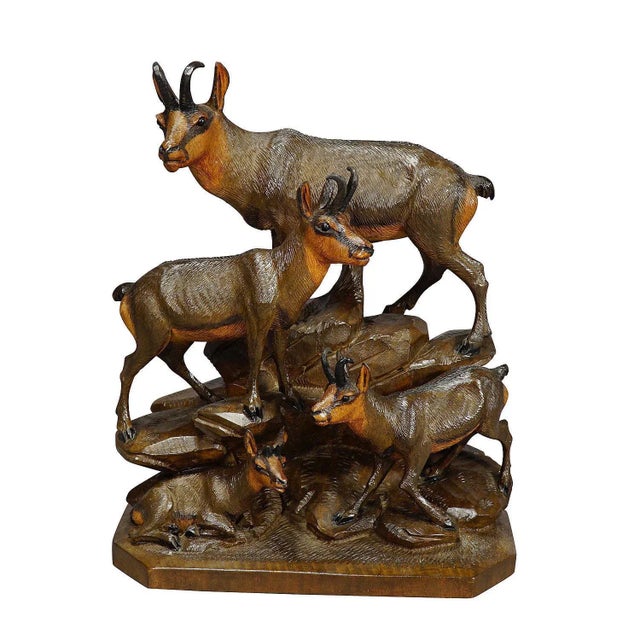 A hand carved wooden sculpture of a chamois group with buck, chamois and fawn. A very fine and natural carving by the...