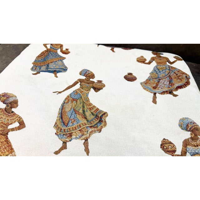 African women in motion, each carrying a clay vessel, are woven across a clean ivory ground in warm amber, gold, and blue-...