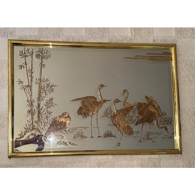Elevate your space with this striking vintage 1980s Hollywood Regency wall mirror, featuring an exquisite, deeply detailed...