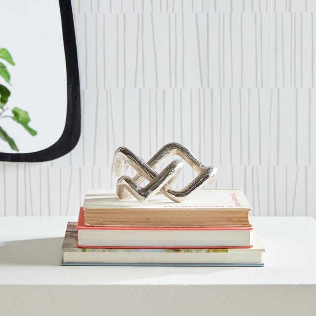 This simple silver composition in cast aluminum is a modern statement of simplicity. A great accent piece for home office,...