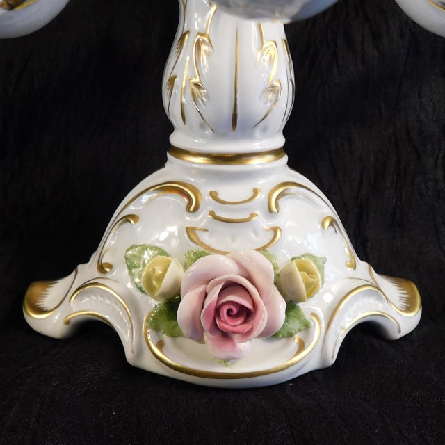This is an Alboth and Kaiser five candle candelabra in white with pink and yellow dimensional flowers (or Capodimonte...