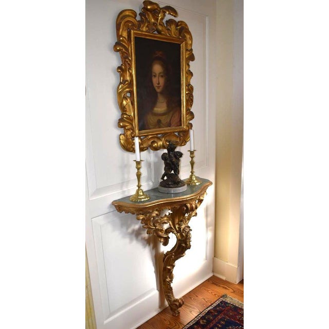 Petite but robust in style , a bold Console of the Rococo Louis XV era . The recurrent themes of 18th century France are...