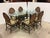 Design Plus Gallery presents a Vintage McGuire Furniture Dining Set. The table has a beveled oval glass top set over an...