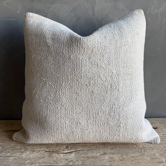 Creamy white hemp rug pillow with original seams. Soft hand, linen blend backing with zipper closure. Spot cleaning is...