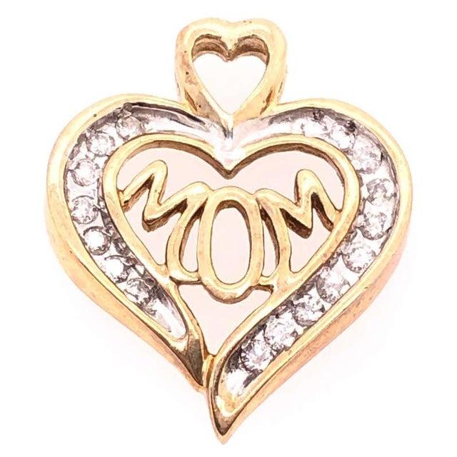 14 Karat Two Tone Gold And Diamond Heart Charm Pendant With MOM Center 0.60 TDW. 2.83 grams total weight.