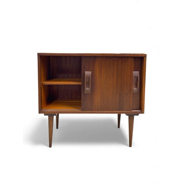 Pair of two oversized nightstands/cabinets in dark walnut. Features sliding doors with walnut hardware on top of classic...