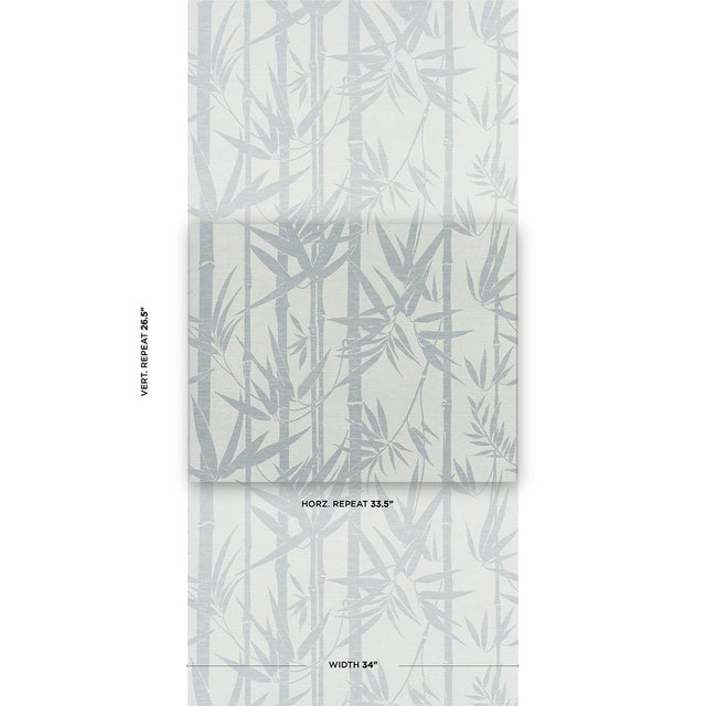 A silhouetted pattern of multiwidth bamboo stalks and overlapping foliage, Les Bambous Sisal in green-on-sand evokes the...