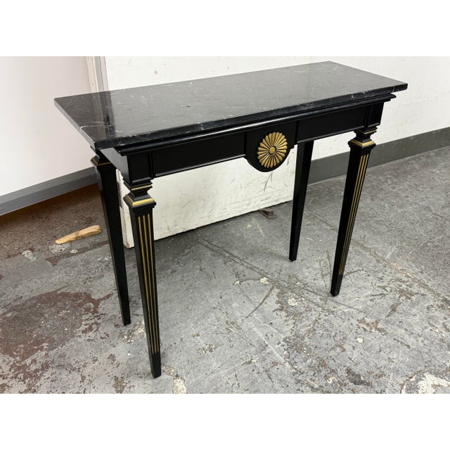 Design Plus Gallery presents a Vintage Empire Style Console. The console is made from solid wood and it has a black finish...