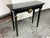 Design Plus Gallery presents a Vintage Empire Style Console. The console is made from solid wood and it has a black finish...