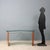 Desk with base in Tanganyika walnut veneer and metal, transparent glass top. This piece is attributed to the mentioned...