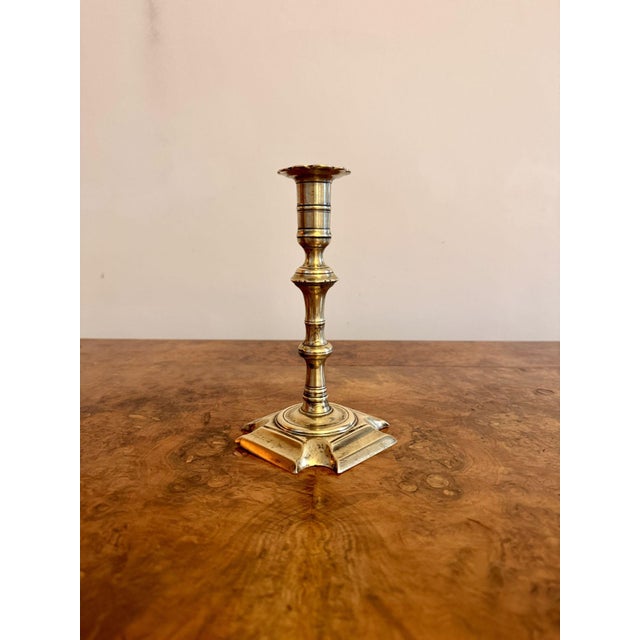 Quality antique Queen Ann brass candlestick, having a quality original antique Queen Ann brass candlestick raised on a...