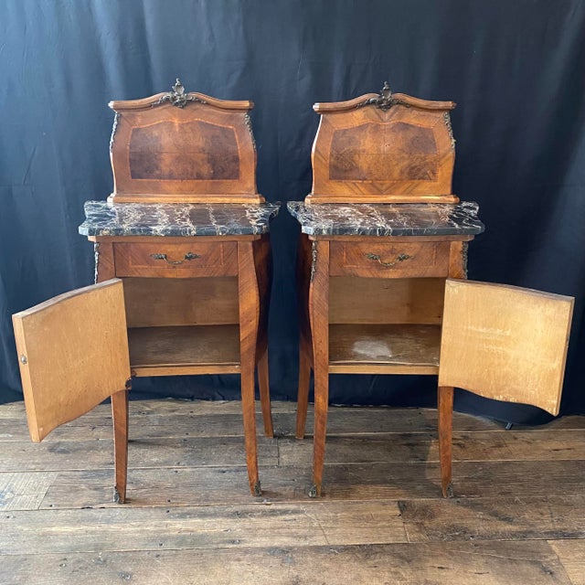 Elegant pair of antique French Louis XV nightstands, side tables or bedside cabinets crafted in richly figured walnut with...