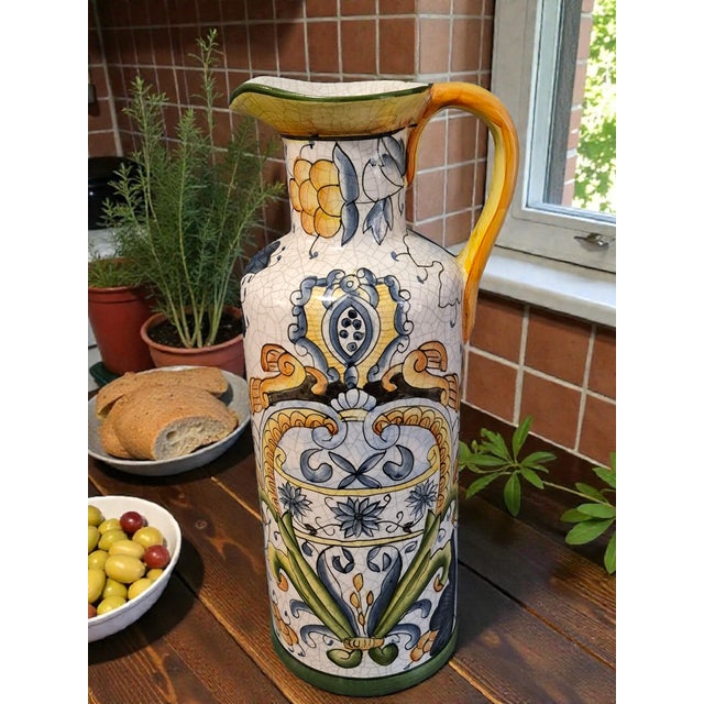 This Crackle Ceramic Italian Ewer Pitcher features a beautiful Tuscan Deruta Motif in multiple colors, adding an artistic...