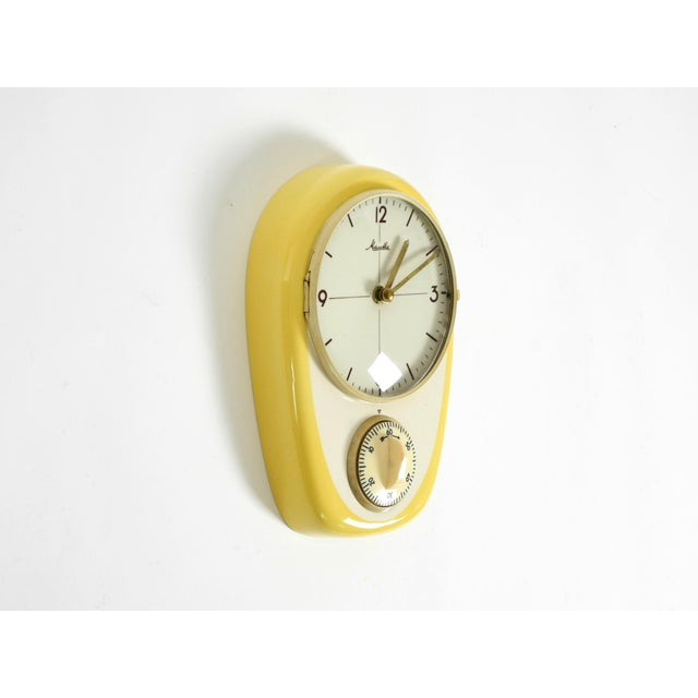 A very rare and beautiful battery-operated mid-century modern wall clock featuring an additional mechanical timer....