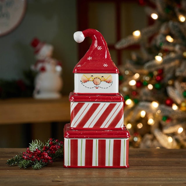 Add a touch of whimsical holiday charm to your decor with this Ceramic Stacking Santa Canister Set. Featuring a jolly...