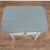 19th century Swedish side table with two drawers, crafted in pine. The table retains a lovely blue painted finish that is...