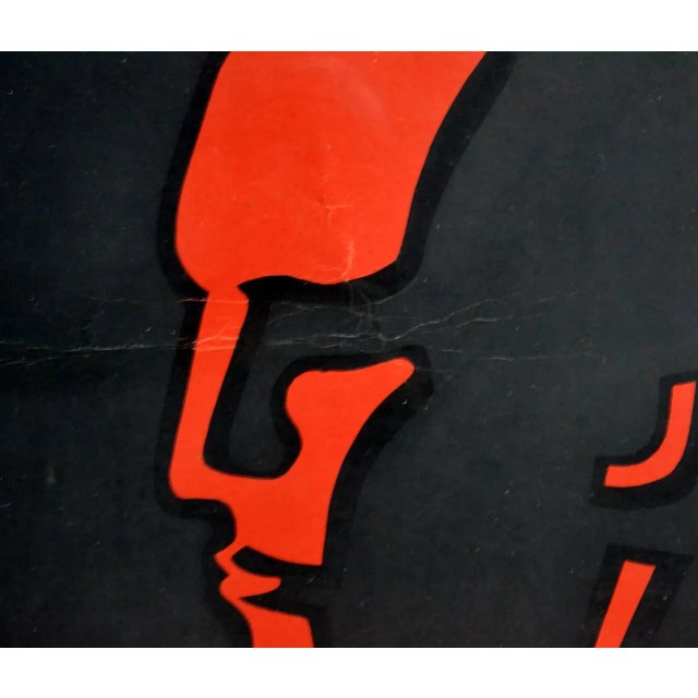 - Red and black poster advertising Ciney ovens - With a strong image of a working man with a hammer - Ciney logo below and...