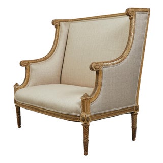 French 19th Century Louis XVI Style Giltwood Wingback Settee with Carved Motifs For Sale