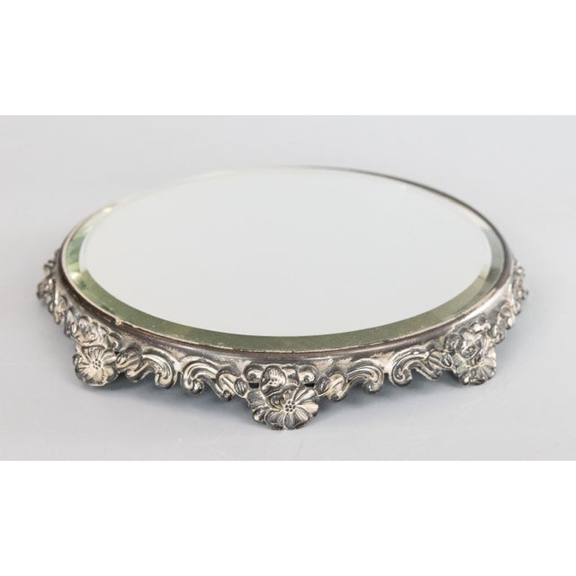 A lovely antique silverplate mirror plateau, circa 1920. No maker's mark. This beautiful plateau has an ornate floral...