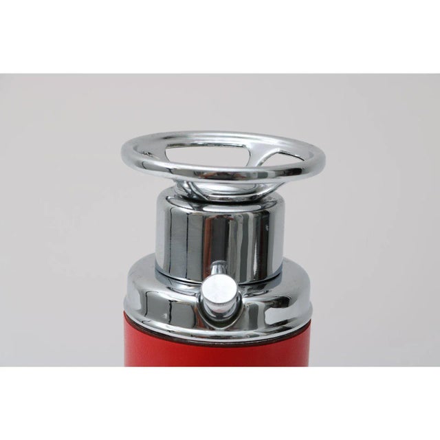 Unique novelty fire extinguisher decanter. Circa 1950s. Plays a song when underside knob is twisted (see photo).