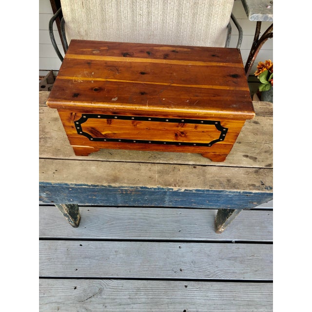 Small cedar box with nail head trim on front and double handles