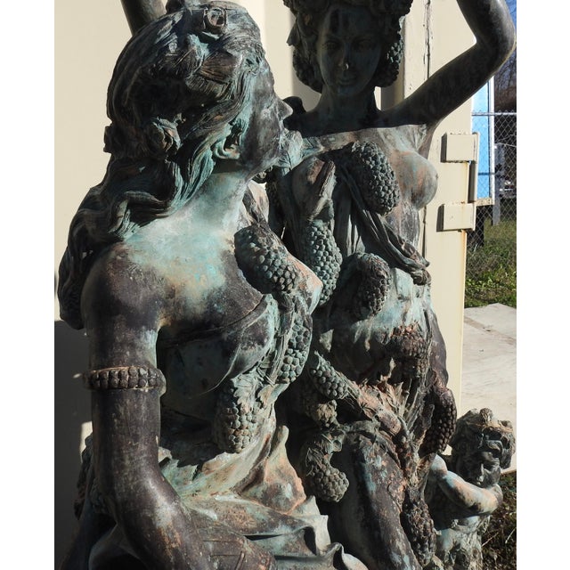 Two women and children in a stunning patinated bronze are celebrating the harvest of the grapes. They are enveloped in...