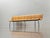 A sculptural wooden bench with elegantly curved lines, crafted from molded beech plywood. The continuous seat and backrest...