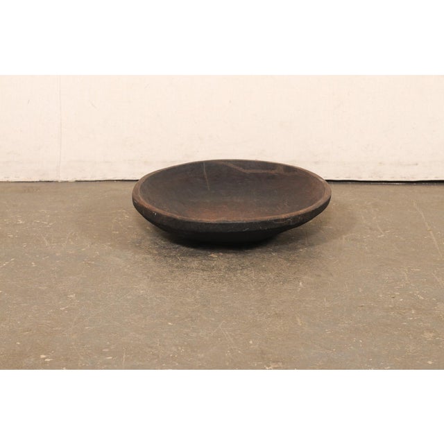 A Sumatran hand-carved wooden bowl from the early 20th century. This antique bowl from Sumatra has been masterfully hand-...