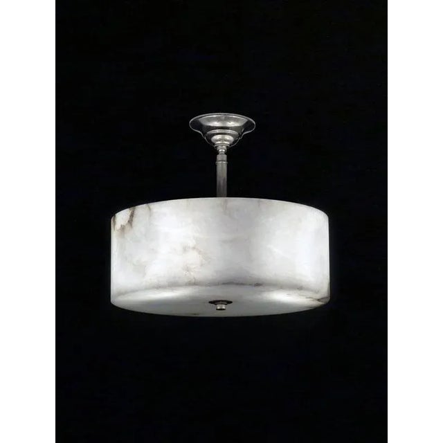 Round alabaster pendant. shown hanging with stem, can be drilled for chain