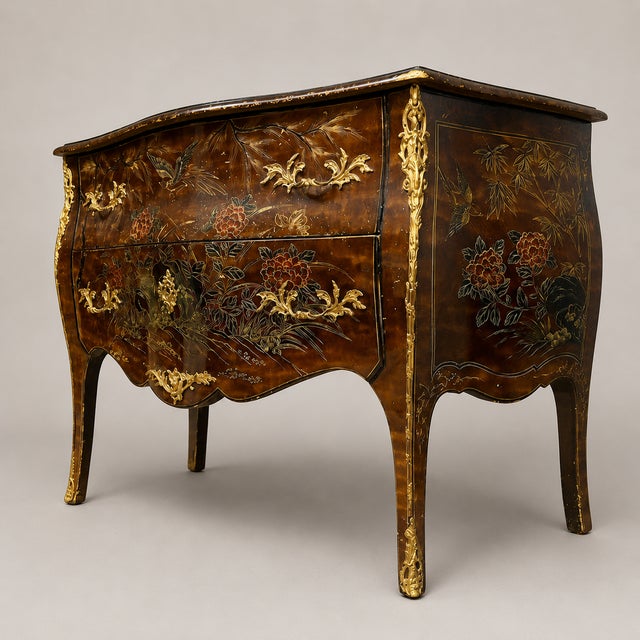 A curved lacquer commode with chinese-style decoration, dating from the early 20th century. The front opens with two...