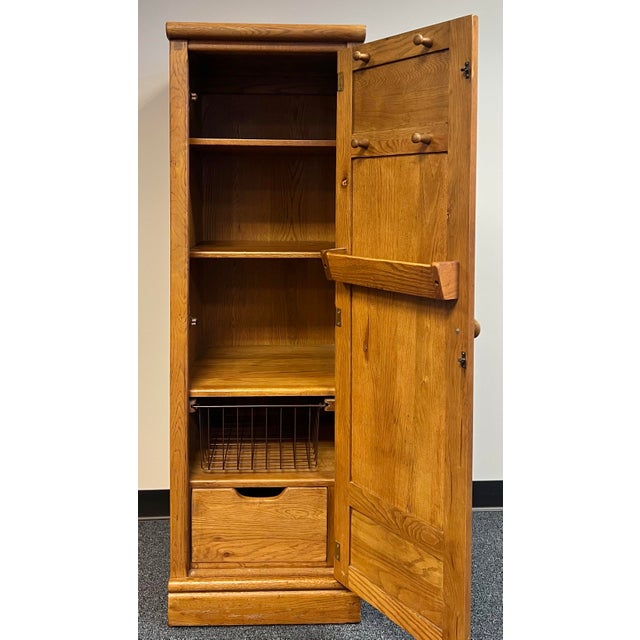Great little oak storage / pantry cabinet by Lexington furniture. Locker type design with a full length door with...
