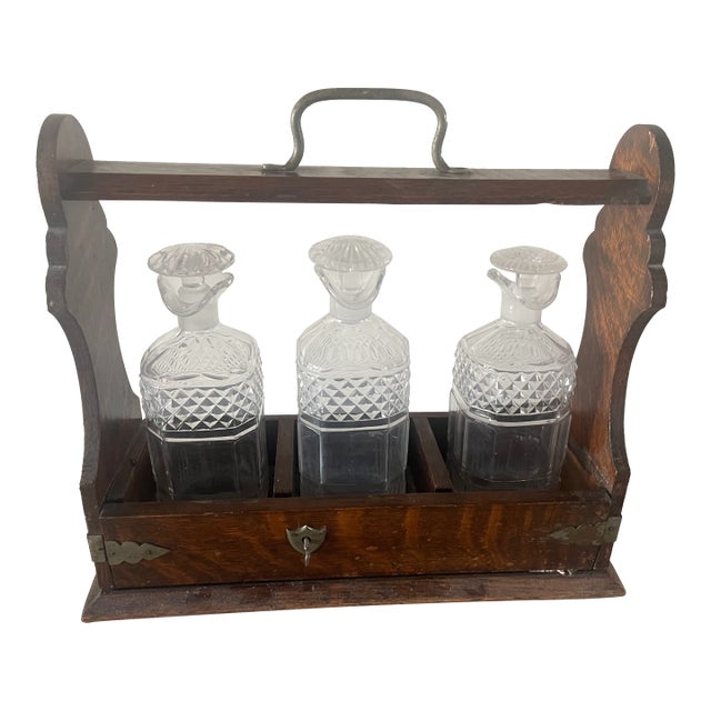1910s English Oak Arts & Crafts Bareware Caddy Lockable Tantalus With Three Crystal Decanters For Sale