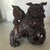 Hand carved wooden pair with beautiful attention to detail. Dogs are perched on a ball that has been carved inwardly while...