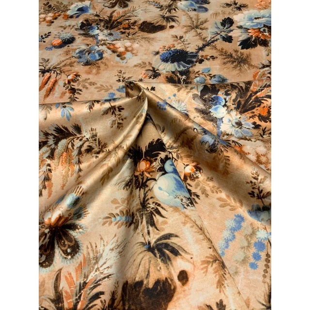 This elegant floral sateen has a vibrant colorway, including blues, oranges, and other neutral tones/ It has a soft hand...