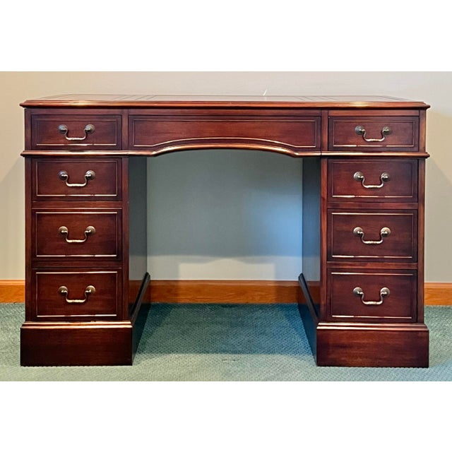 Gorgeous mahogany regency style writing desk by Colonial Manufacturing. Gold embossed brown leather three section top....