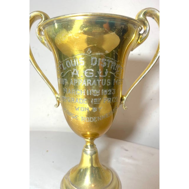 Up for sale is a wonderful antique 1923 gold toned silverplate Indoor Apparatus Meet trophy. It has a beautiful form with...