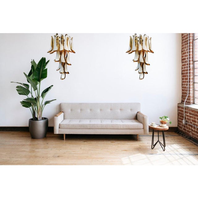 Pair of Vintage Italian Murano wall sconces. Wall lights have 16 caramel and white“lattimo” glasses (for each applique) in...