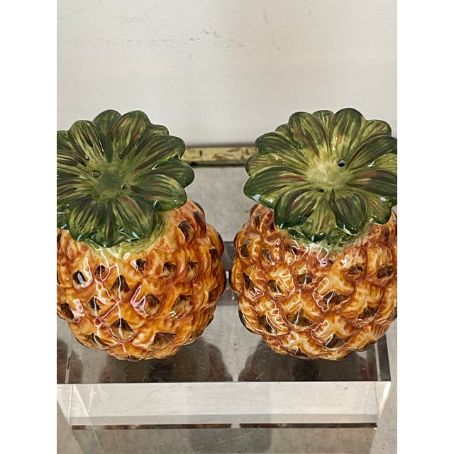 Pair of cute salt and pepper shakers in the shape of pineapple.
