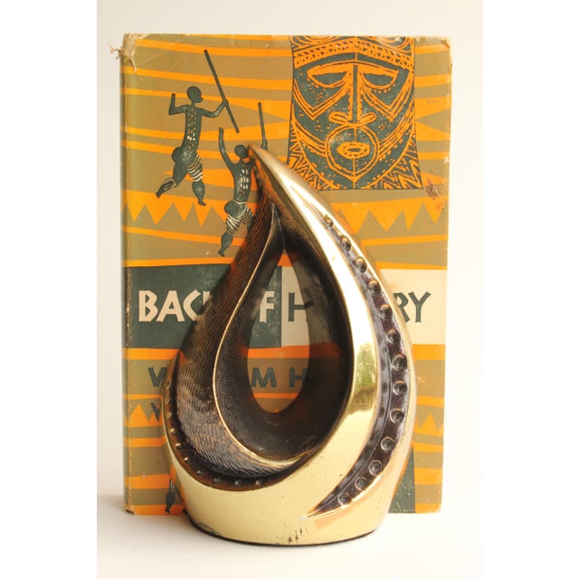 Vintage brass tone bookends with stylized flame motif by Ben Seibel for Jenfredware, circa 1950.