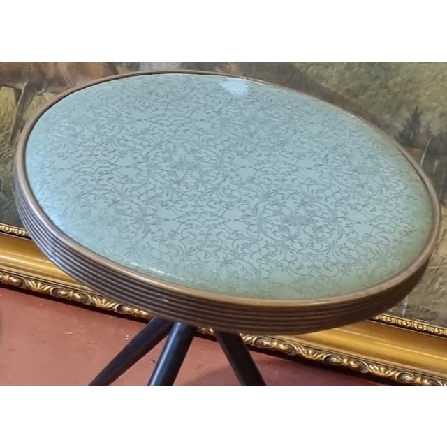 Pair of Mid-Century Italian Design Green Ciré Material Round Stools The stools feature three legs made of metal and brass....