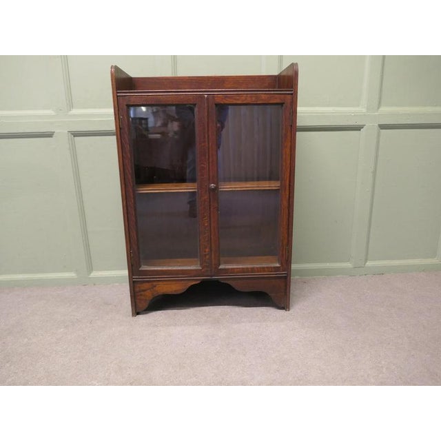 Small Oak Glazed Bookcase/Cupboard with Gallery This is a very useful piece, it set on bracket feet and has 2 glazed doors...