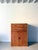 An early 20th century limed oak tallboy cabinet by heals of london. This 1930s vintage wooden cupboard has a shelved...
