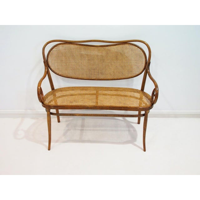 Rare Vienna Secessionist bentwood and rattan settee by Thonet Brothers. The settee can be found in old Thonet catalogues...
