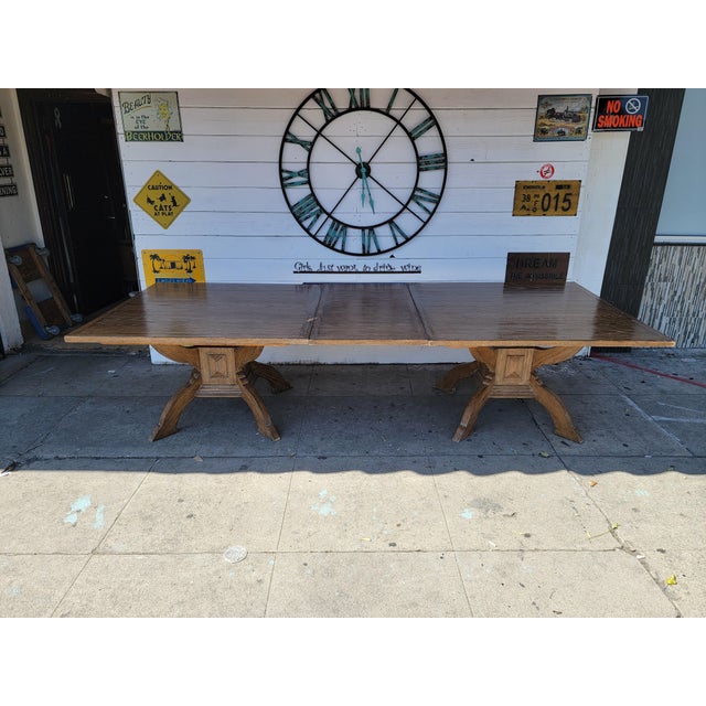 Vintage modern long solid oak wood dining table. Has a leaf in the middle can remove to make it two 48" square table. Two...