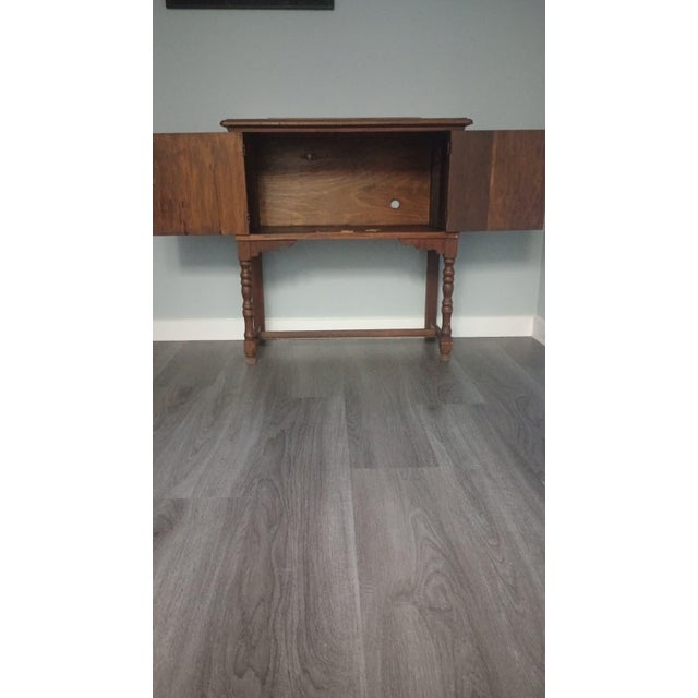 This beautiful vintage wooden cabinet or console table features classic Jacobean Revival design elements such as the...
