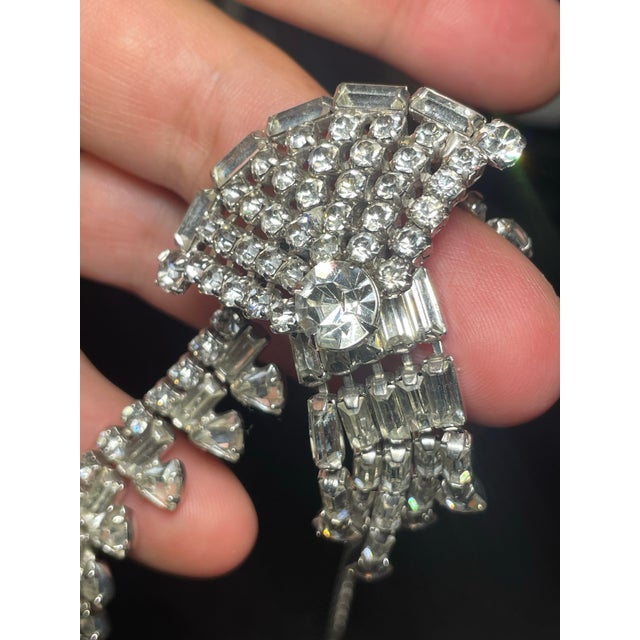 Crafted during the 1950s post-war era of Hollywood glamor, this clear crystal statement necklace showcases the Art Deco...